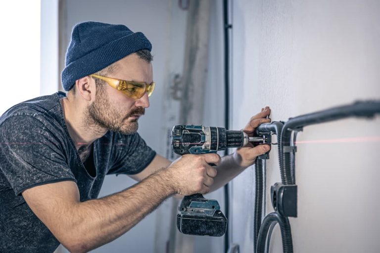 Electrician Is Mounting Electric Sockets White Wall Indoors 2 Web